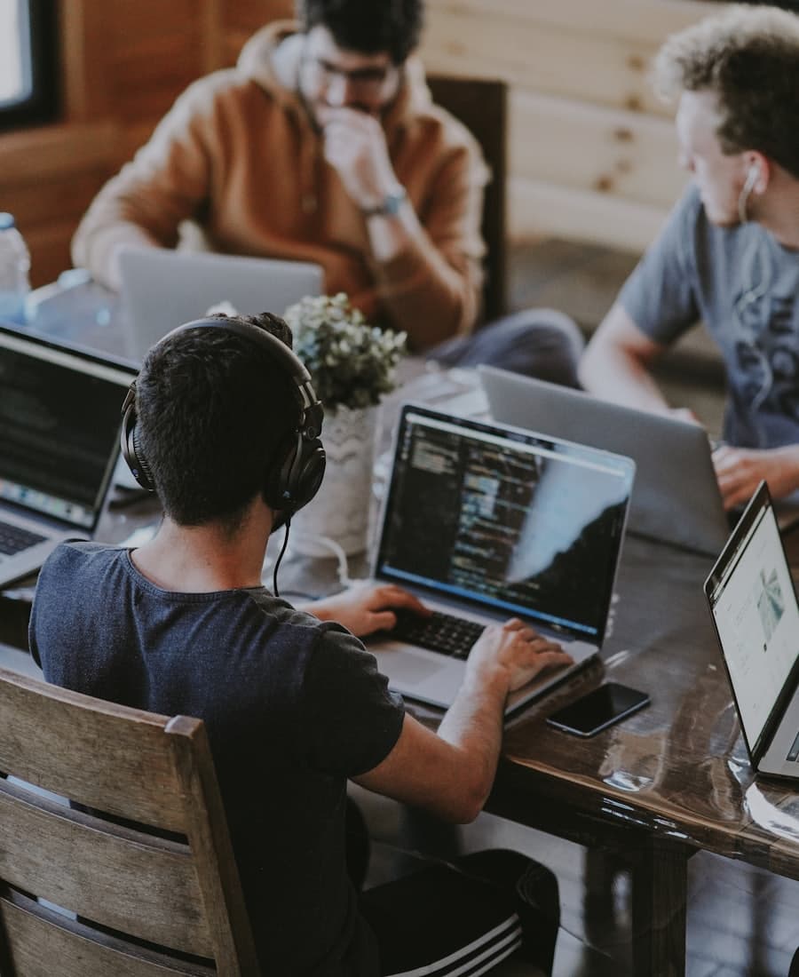 Agency team working on laptops around a table