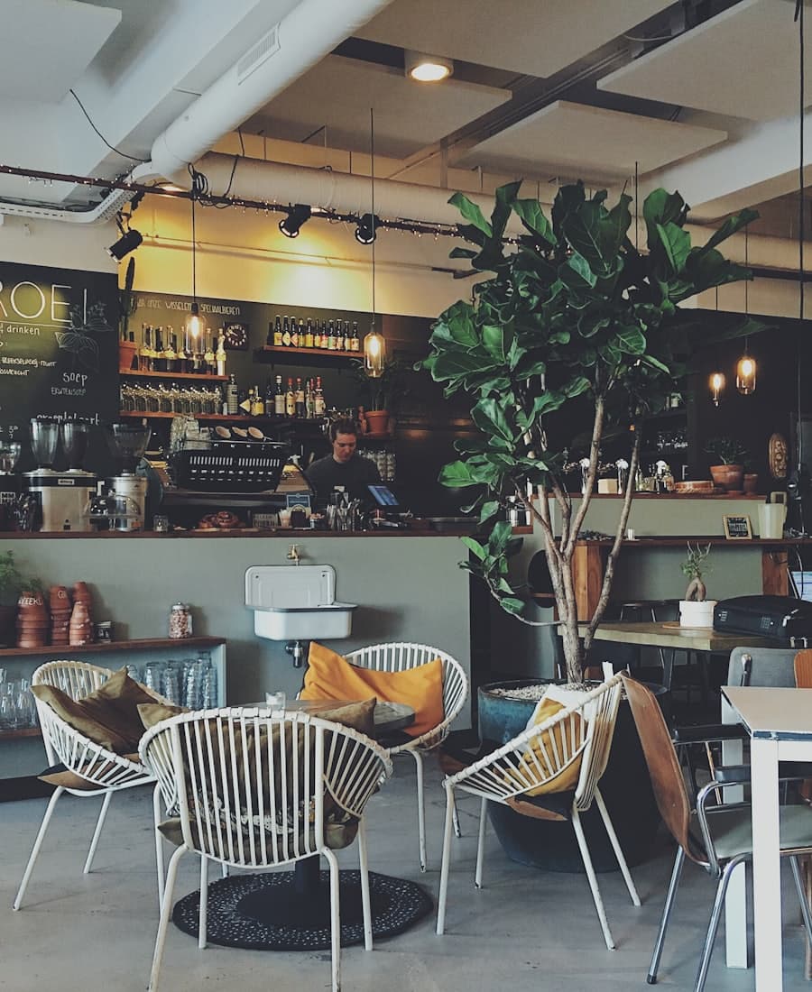 Cafe interior with cane chairs and an espresso bar