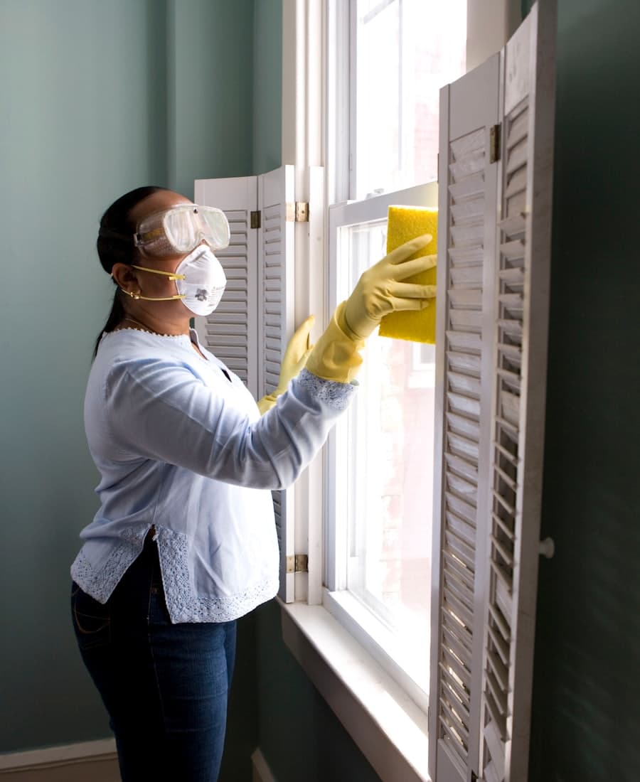 Cleaner wiping down a window frame